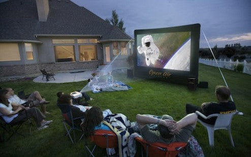 An outdoor movie on an Open Air Cinema inflatable screen in a backyard