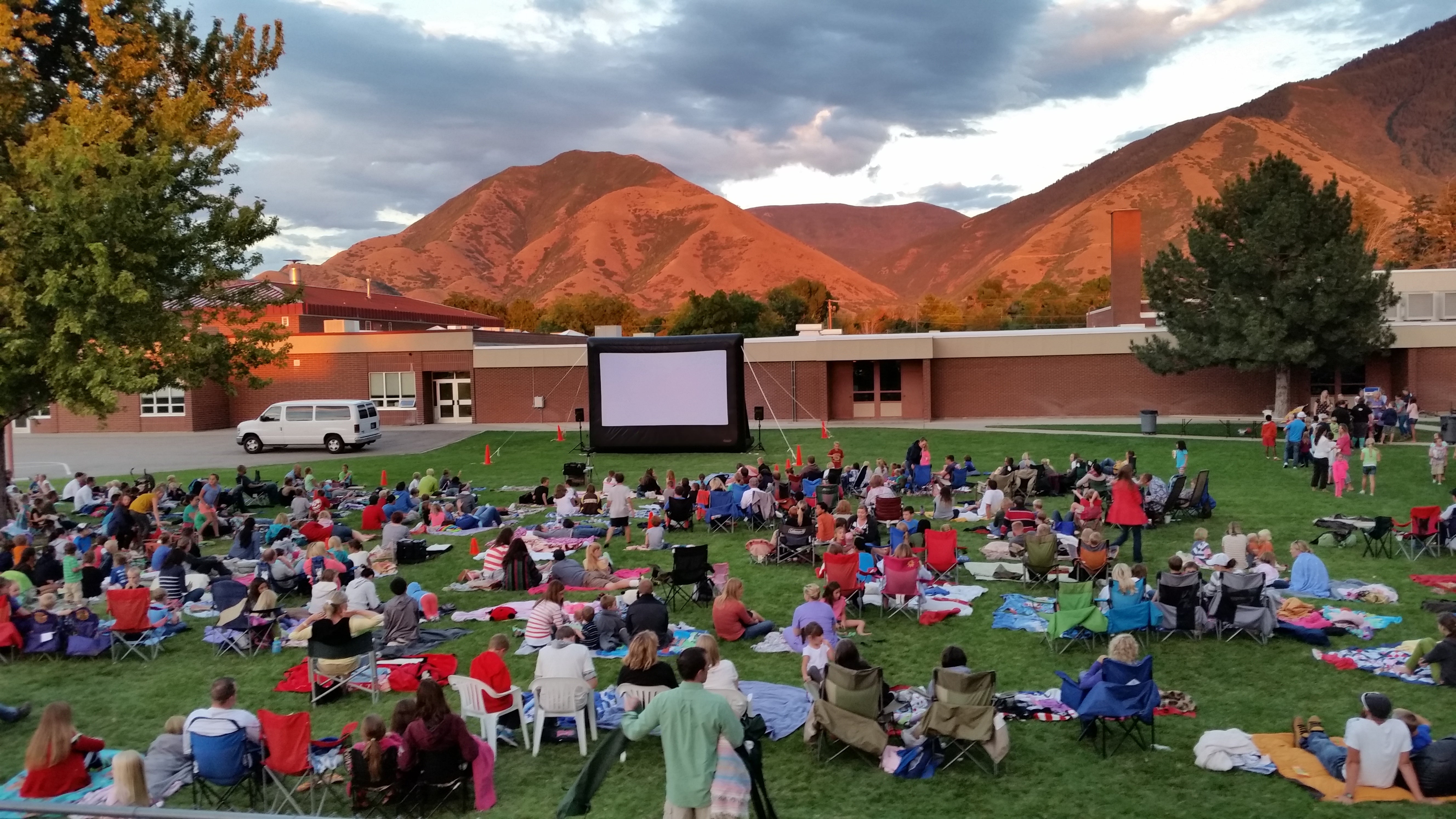 Audience on blankets at a movie in the park