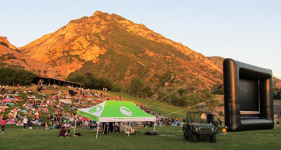 Outdoor movie night on a large inflatable screen in a park