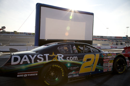 Race fans watching Days of Thunder on a big outdoor screen